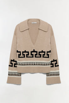 Beige knit sweater with V-neck collar, black geometric patterns across chest and sleeves, ribbed cuffs and hem.
