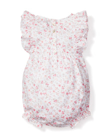 The Babys Twill Ruffled Romper in Dorset Floral by Petite Plume is a white floral romper with pink flowers, Victorian-style ruffled cap sleeves, and a back button closure. Its lightweight fabric adds to the delicate and feminine design, making it ideal for breezy sleepwear.