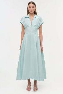 Light blue cotton faille midi dress with collared neckline, short sleeves, and A-line skirt on model wearing white sandals.
