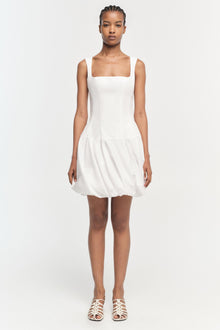 White sleeveless mini dress with square neckline and gathered skirt hem.