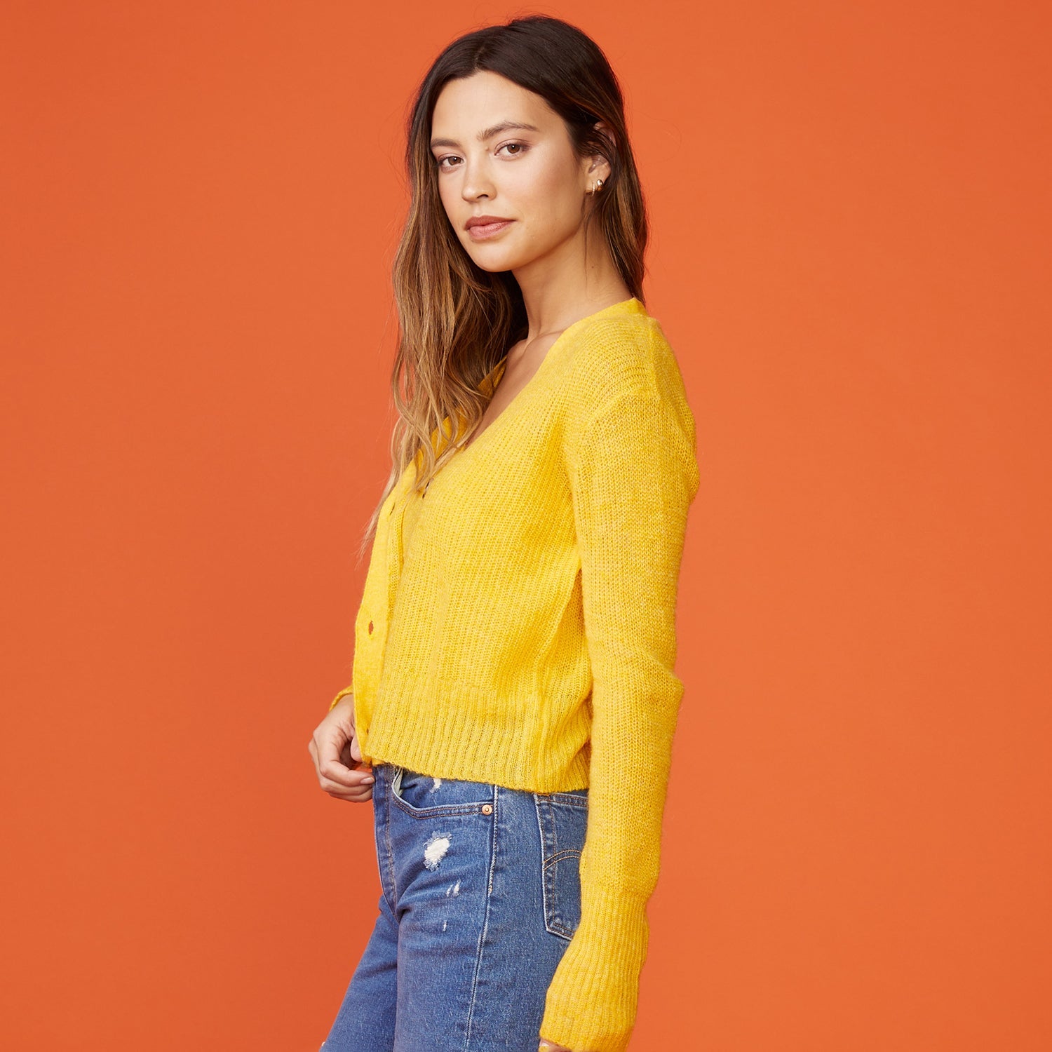 Side view of model wearing the mohair cardigan in sunshine.