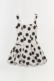 Cream mini dress with black polka dot print and sleeveless square neckline.