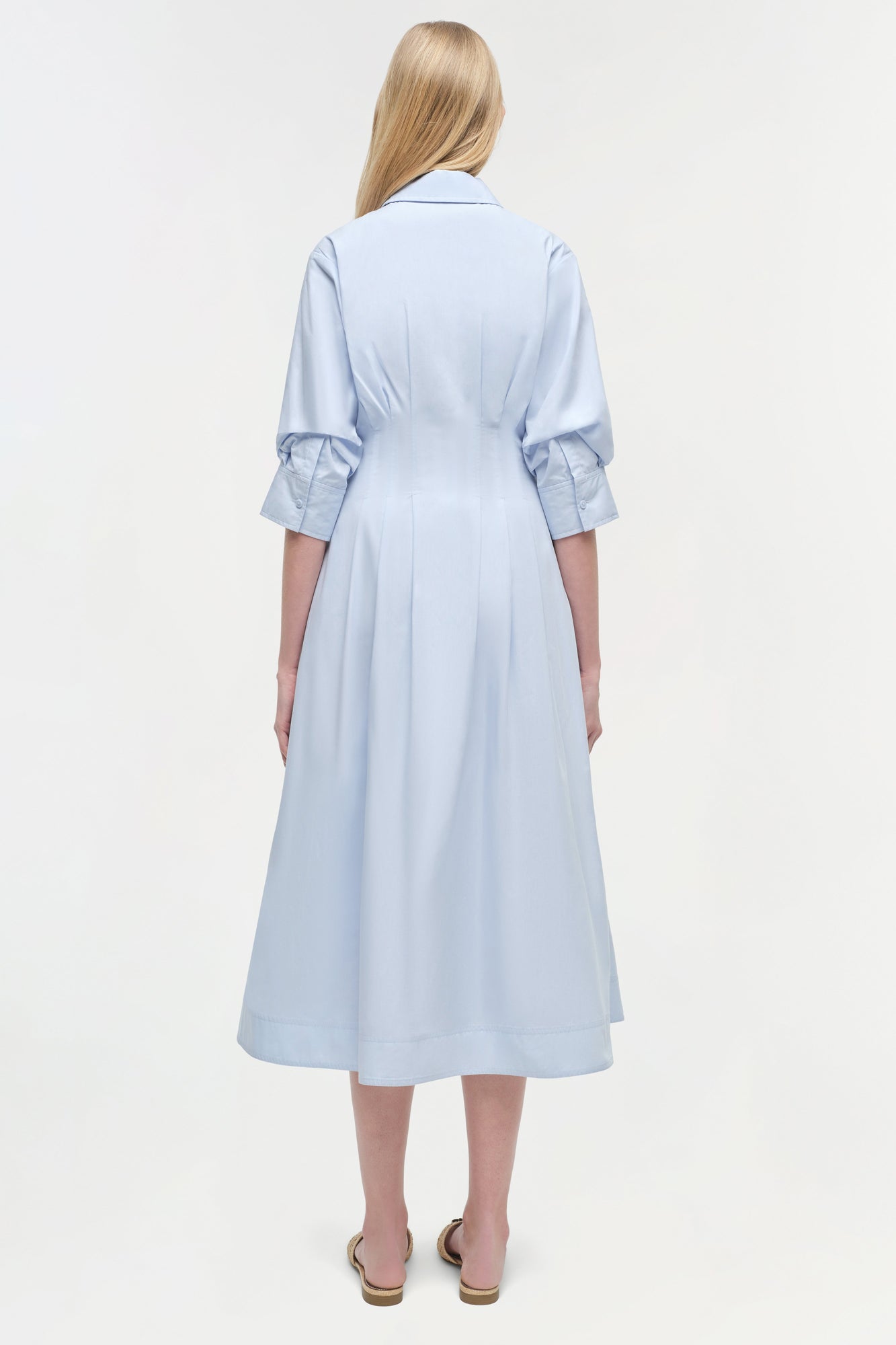 Light blue midi dress with collared neckline and three-quarter sleeves, shown from back view on model.