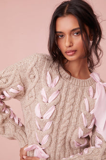 Sweater with chunky Peruvian cable detailing and a charmeuse ribbon threaded throughout.