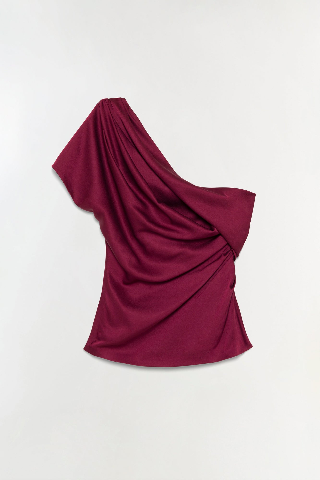 Burgundy satin top with draped one-shoulder neckline and flowing fabric.
