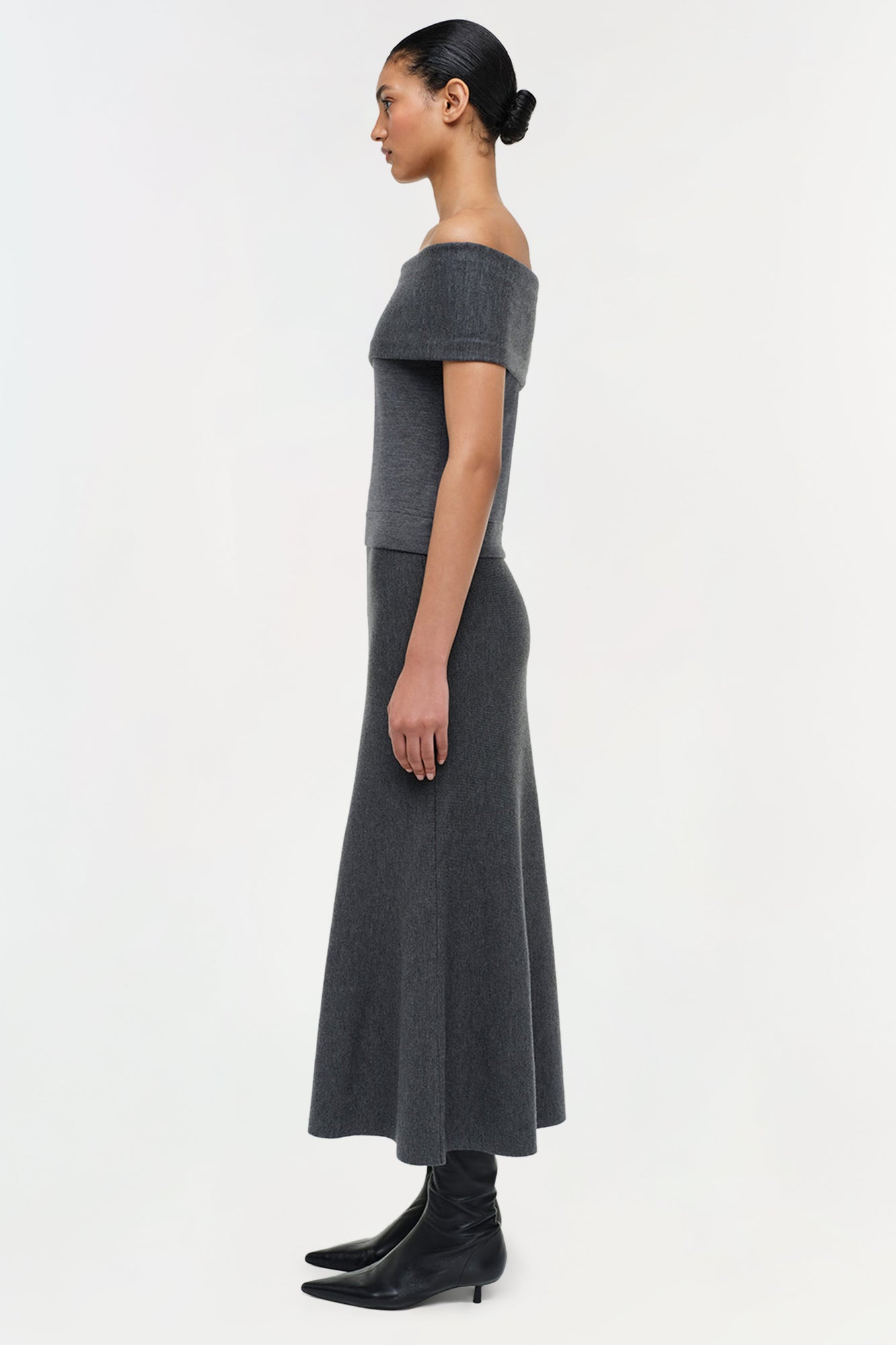 Charcoal gray wool skirt with off-shoulder neckline and flared midi silhouette.