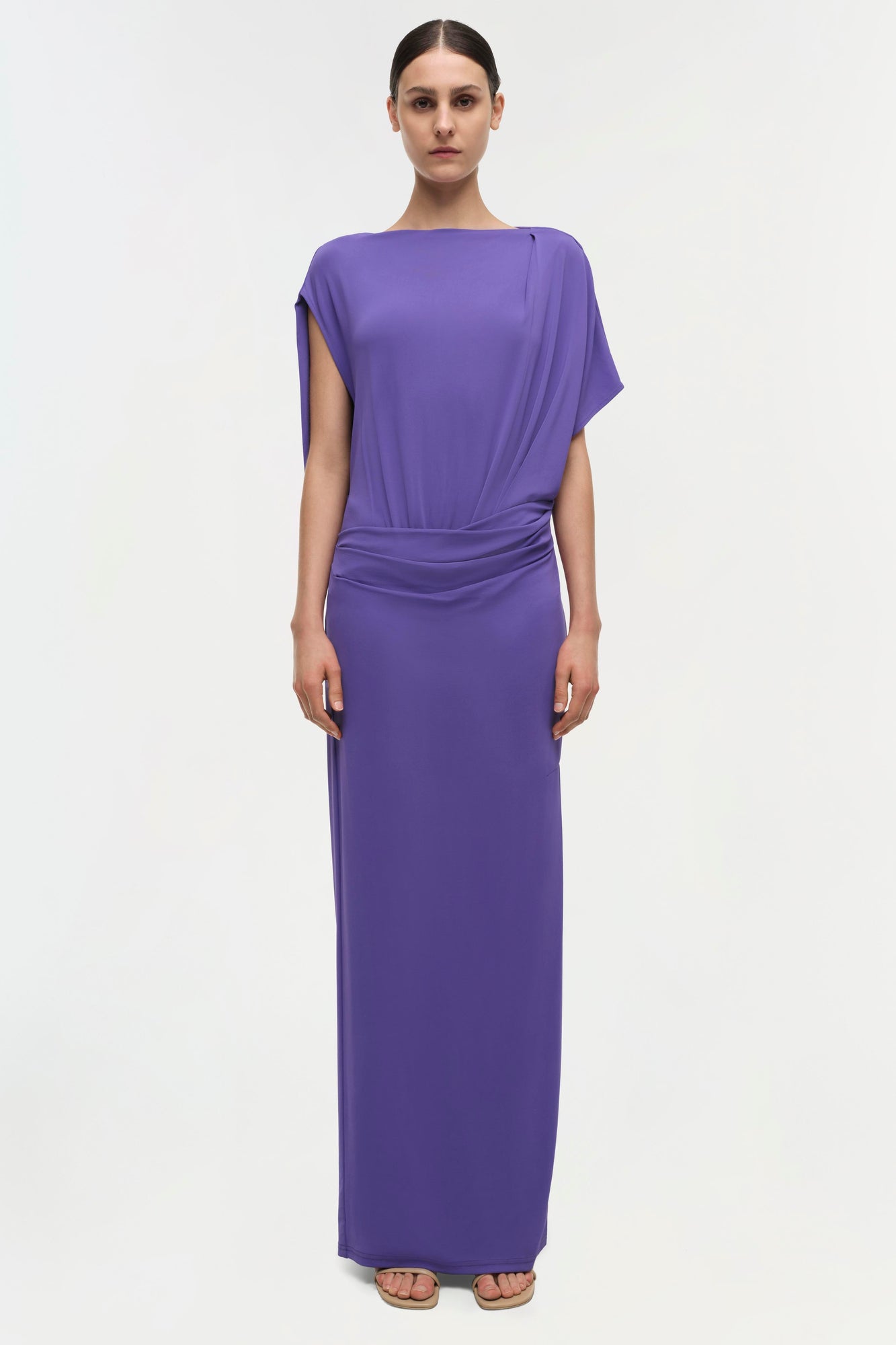 Purple drape gown with short draped sleeves and ruched waist detail at center, floor-length skirt.