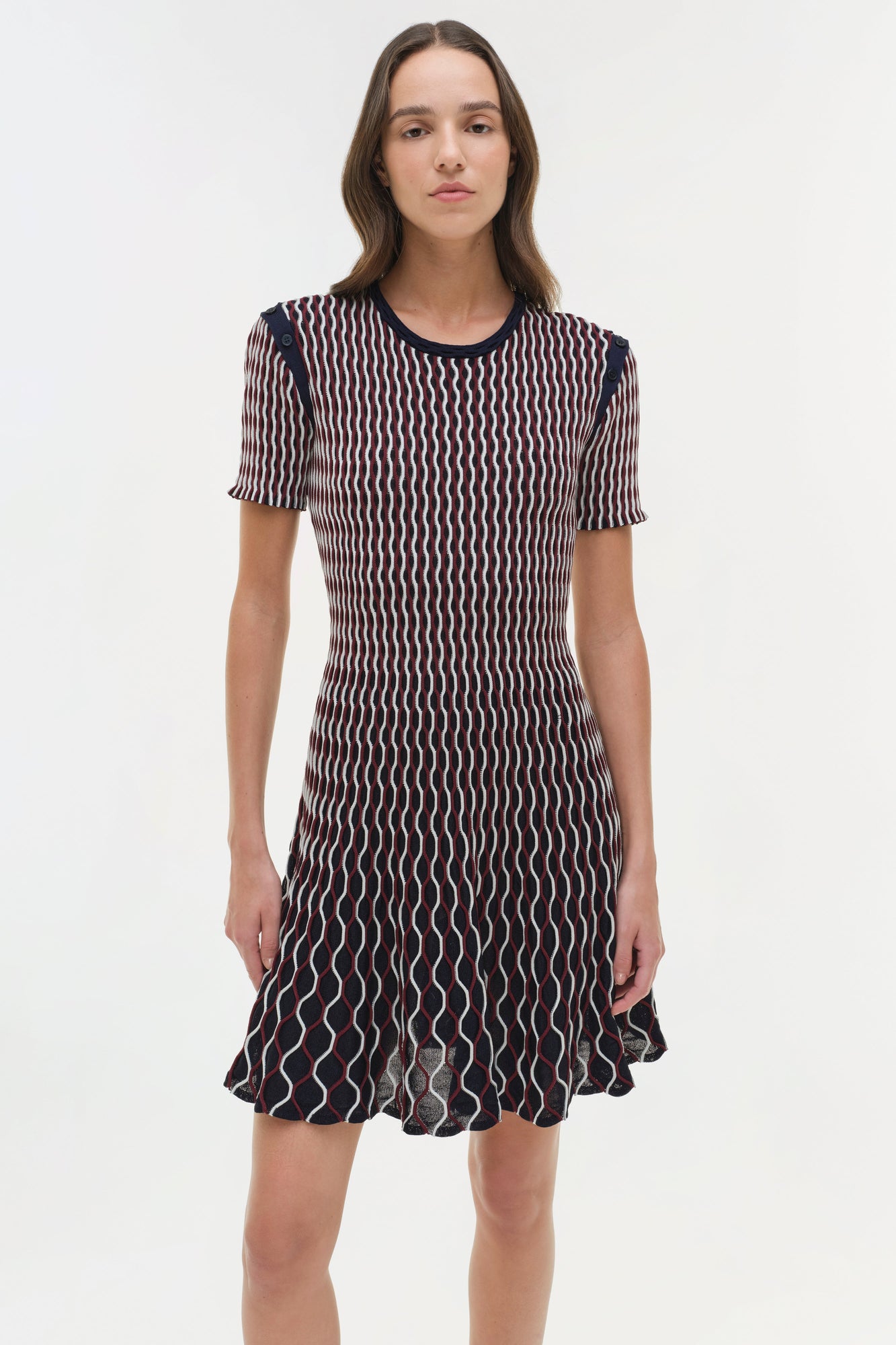 Navy knit mini dress with white wavy vertical stripes, short sleeves, and A-line skirt.