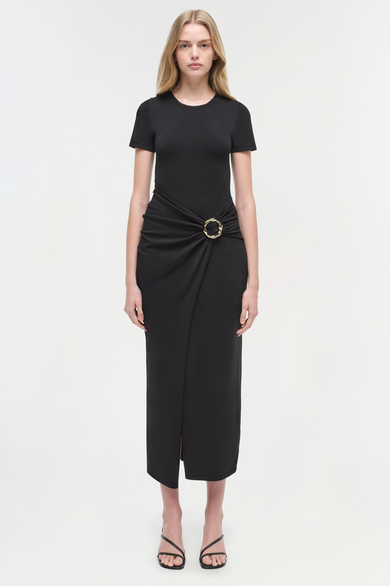 Black knit midi dress with short sleeves, crew neckline, and cinched waist with metal ring detail.