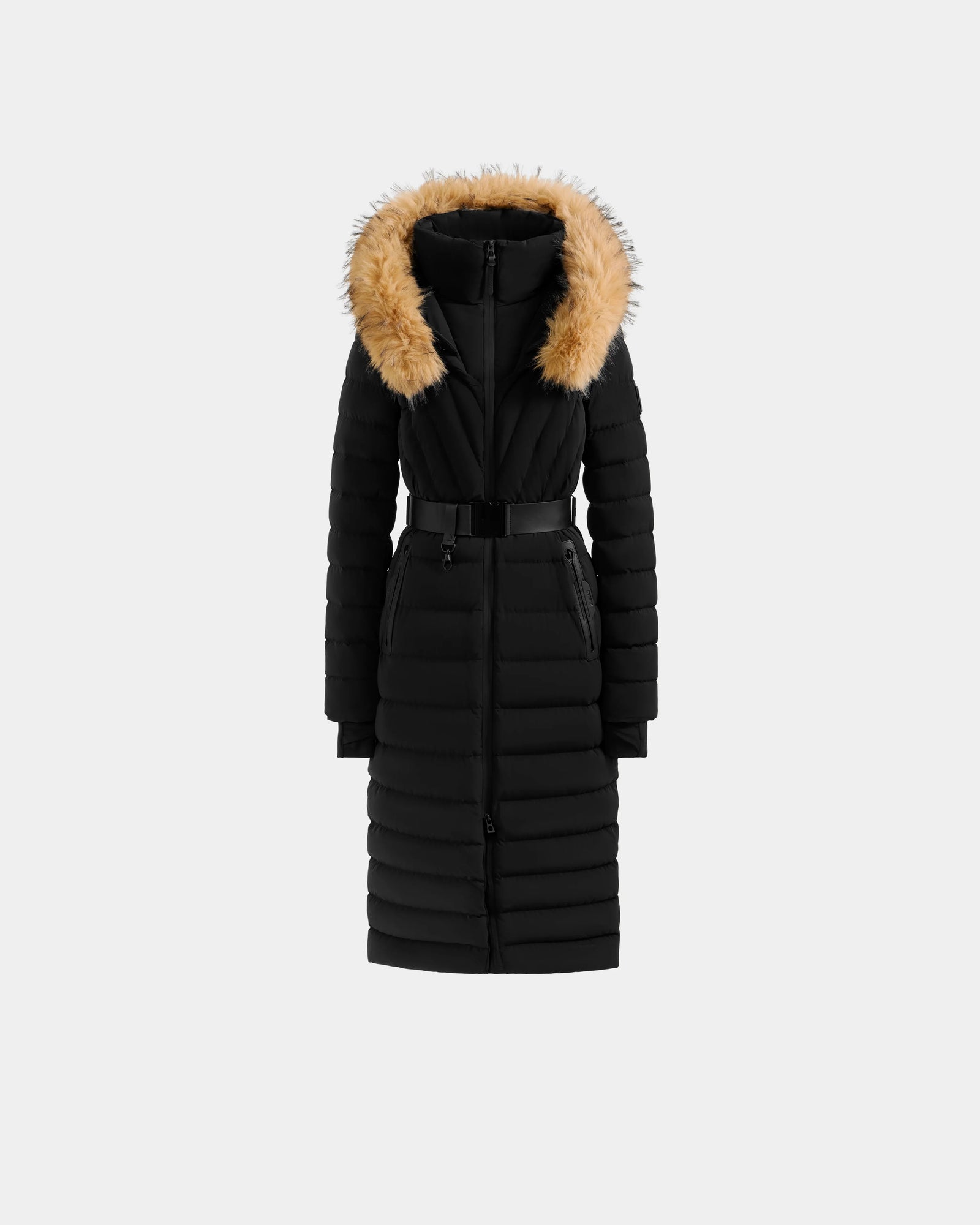 The Rudsak ALISA L - L125574 Black is a long black quilted puffer coat with a belted waist, front zipper, and hood with tan faux-fur trim, shown on a plain light gray background.