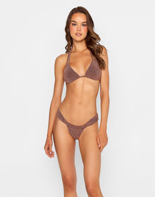 Model wearing the Casey Tri Top and Delphin Tango Bottom in brown shimmer fabric, featuring ruched detailing, from the latest swimwear collection.