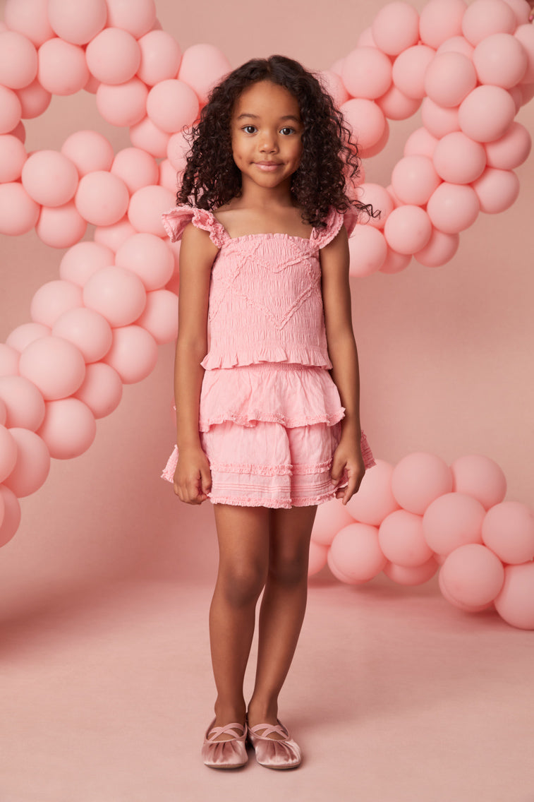 Girls top with tiny flutter sleeves, ruffle smocking all over, and a dainty ruffle peplum hem.