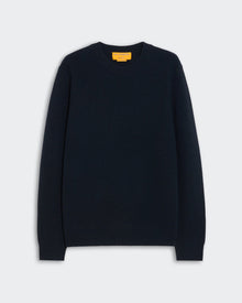 Dark navy blue crewneck sweater laid flat against a light background featuring a ribbed knit texture labeled Rib Allday Crew - Midnight.