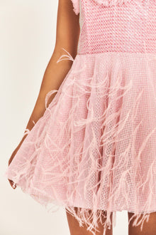 Pink mini dress with structured bodice, boning, and a multi-layered skirt with feathers