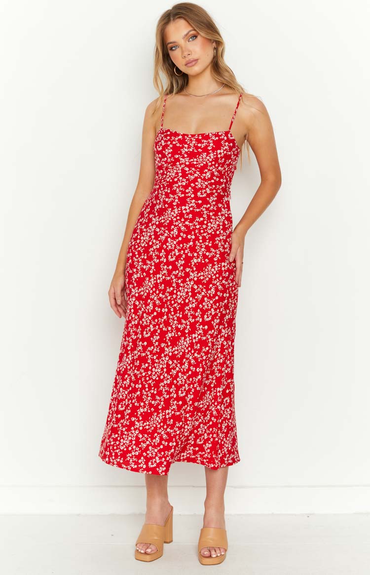 Side view of a red floral midi dress with spaghetti straps and a cutout waist detail
