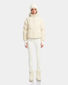 A person in an all-white winter outfit, featuring the Rudsak IKSA - 8124706 Iceland RDS-certified down jacket, fitted pants, knit hat, gloves, and snow boots, stands facing forward against a plain light background.