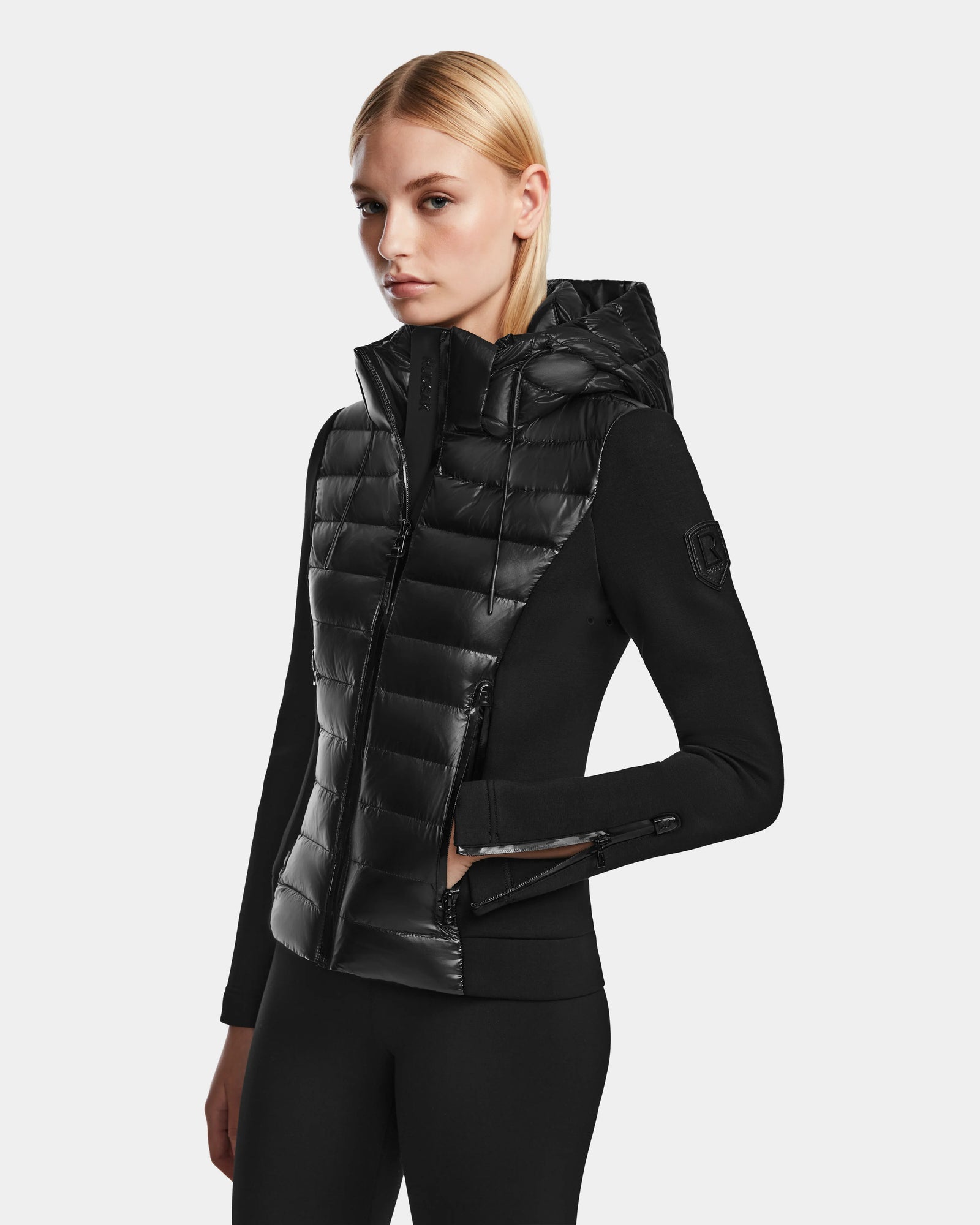 A woman wearing the RUDSAK MABS - 8122020 BLACK womens puffer jacket.