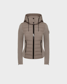 The Rudsak MABS - 8124825 Cement is a taupe women’s jacket featuring quilted panels, long sleeves, black zipper details, and hood drawstrings. This lightweight short jacket is shown on a plain white background.