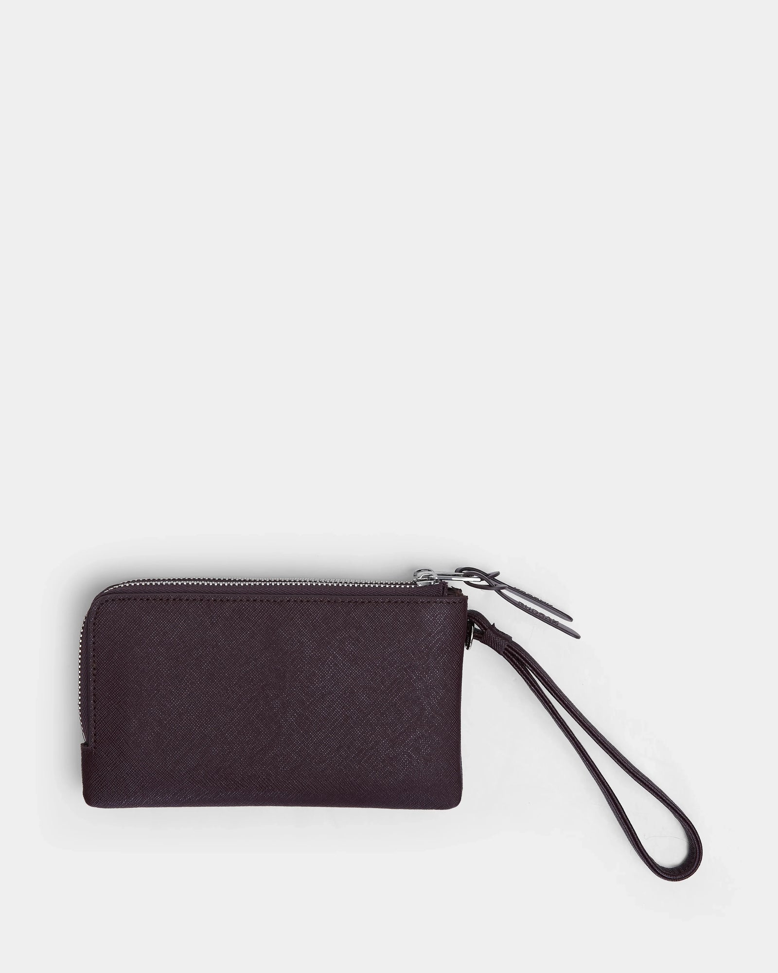 The Rudsak ZURIE - L424501 Wine is a compact, rectangular women's leather wristlet wallet with zippered compartments and a matching wrist strap, shown against a plain white background.