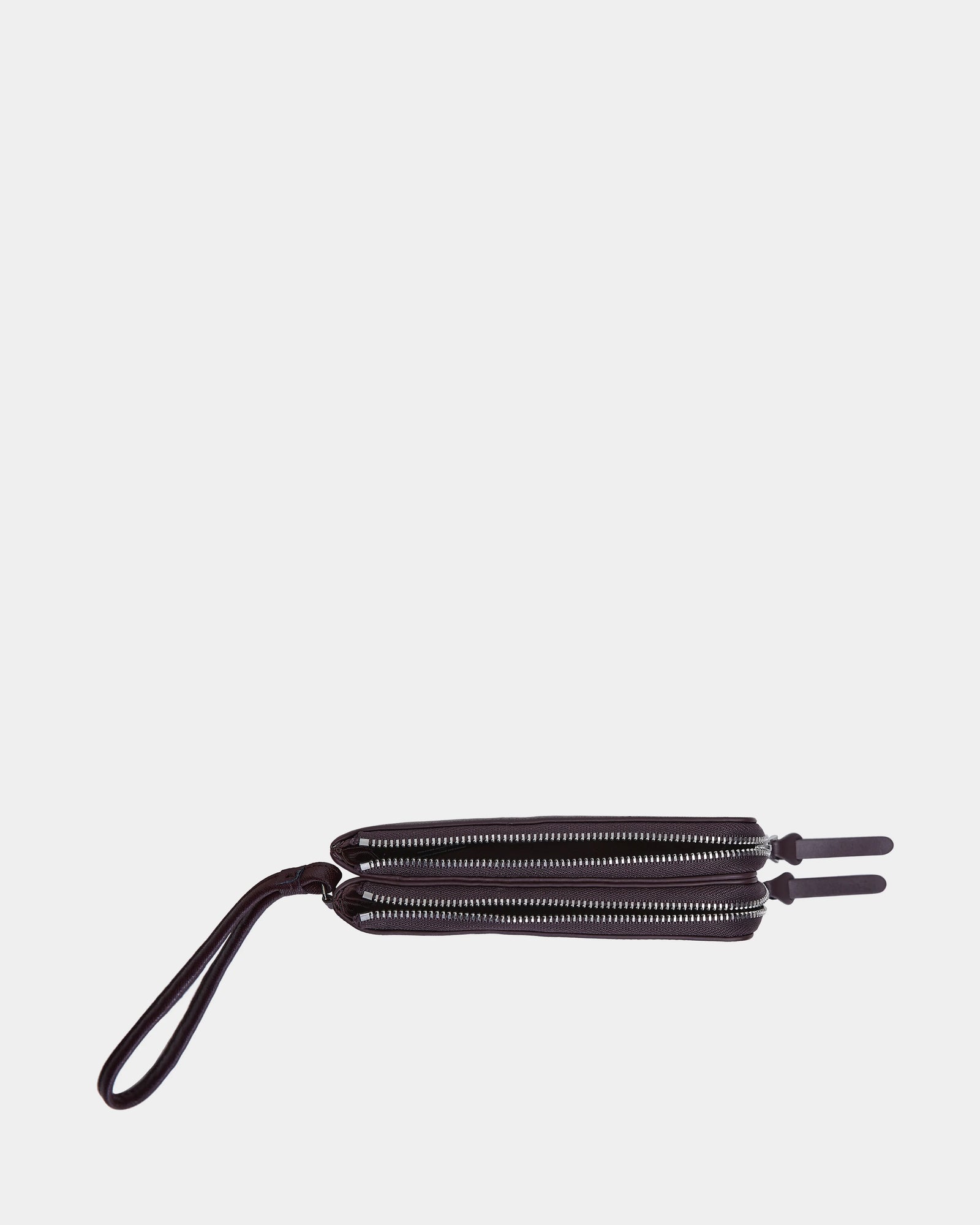 The Rudsak ZURIE - L424501 Wine women's leather wristlet wallet features two parallel zippered compartments and a wrist strap, displayed against a plain white background.