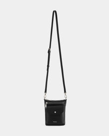 The Rudsak LILA - L325513 Black is a women's crossbody bag in black pebbled leather, featuring an adjustable strap, zippered top, front snap pocket, and small silver hardware, shown against a plain white background.