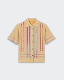 Havana Shirt - Sandstone Combo, a short-sleeve knit shirt in warm beige with vertical and horizontal woven stripes in red and light blue, featuring a classic collar and brown buttons down the front, displayed flat.