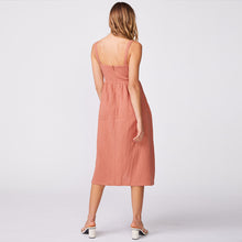 Back view of model wearing the gauze sleeveless maxi dress in faded rust.