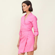 Side view of model wearing the linen mini dress in rose bud.