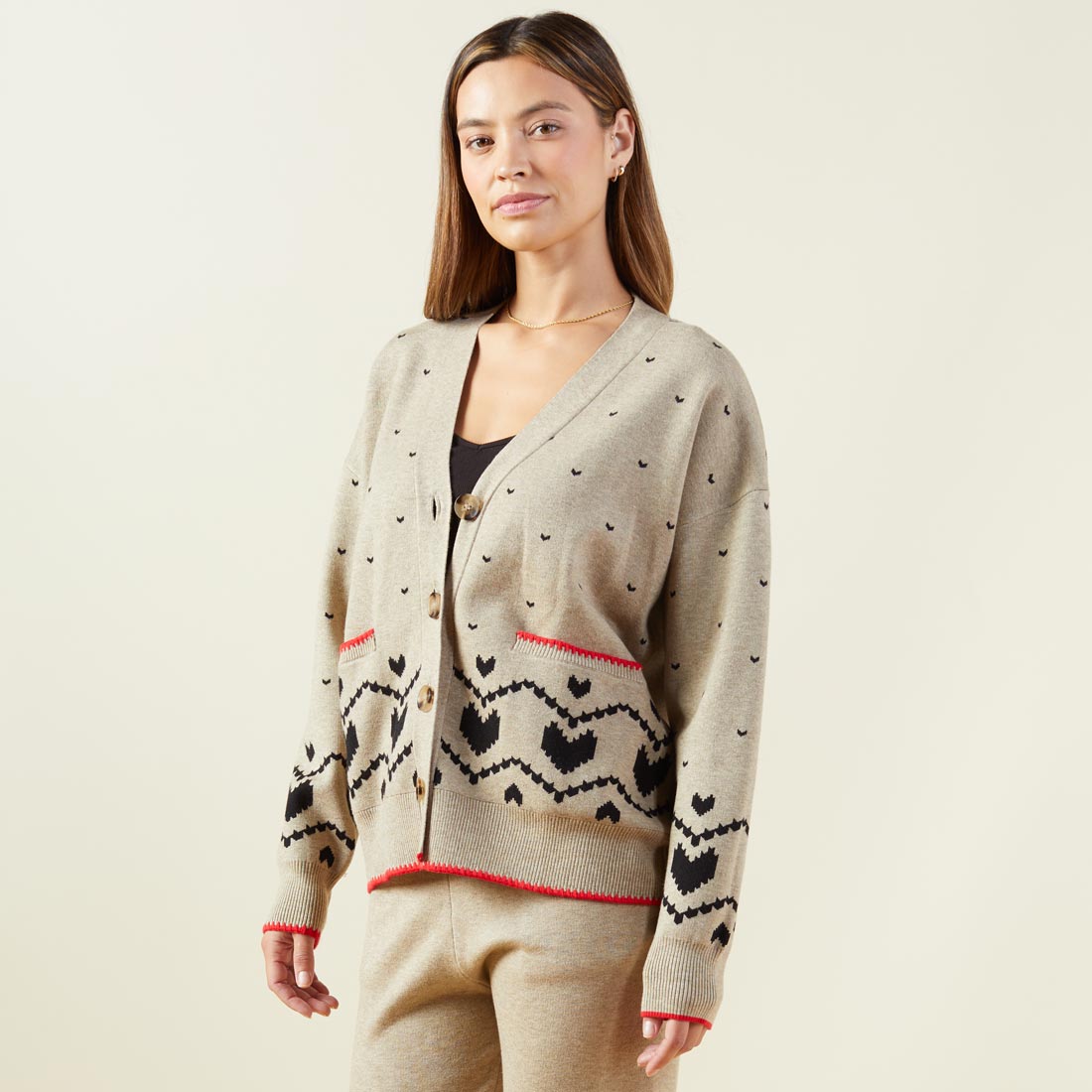 Side view of model wearing the supersoft sweater knit heart fair isle cardigan in oatmeal.