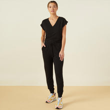 Front view of model wearing the supersoft wrapped jumpsuit in black.