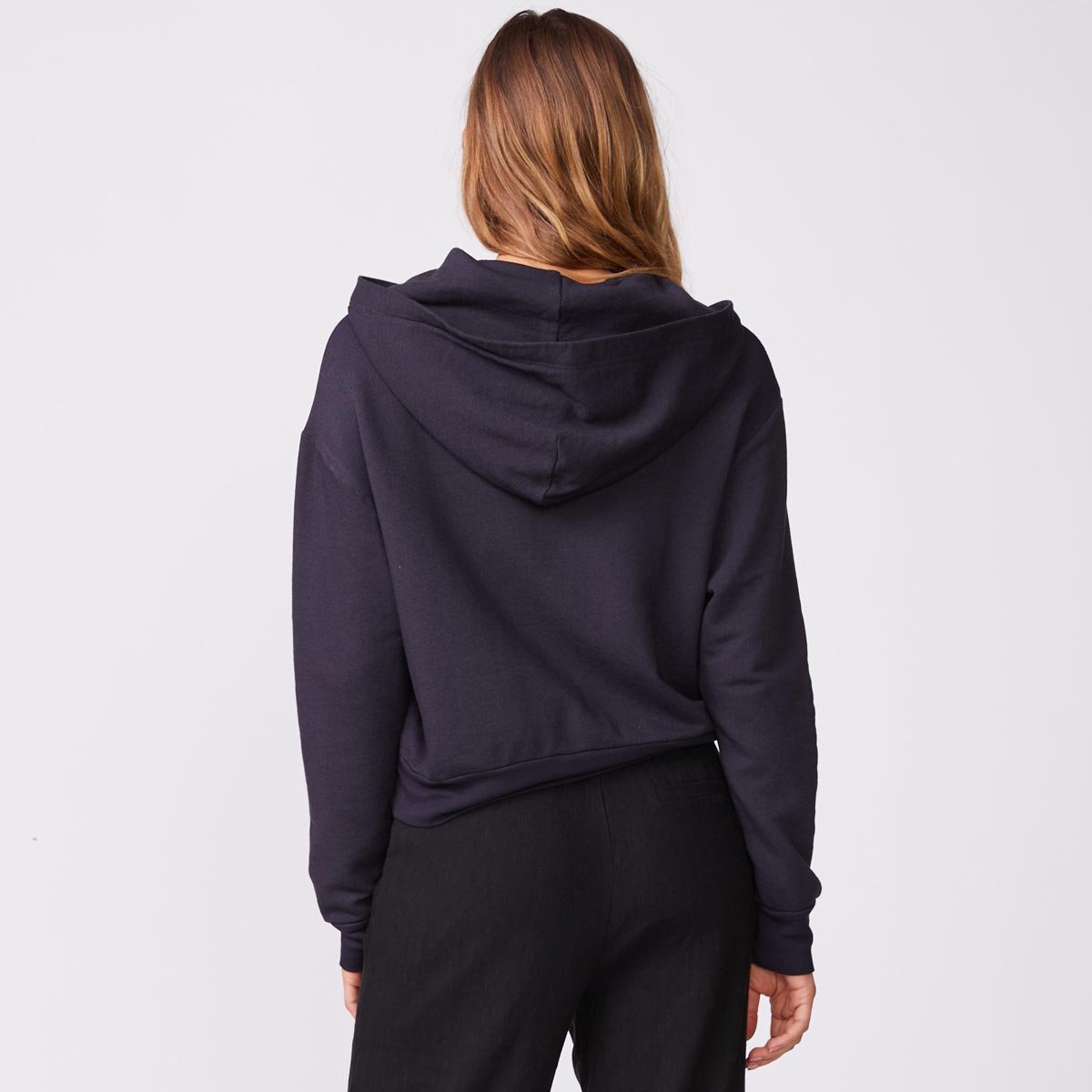 Back view of model wearing the supersoft fleece girlfriend pullover in faded black.