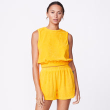 Front view of model wearing the terry cloth tank in marigold.