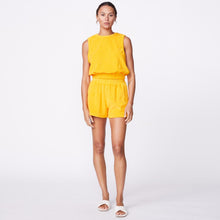 Front view of model wearing the terry cloth tank in marigold.