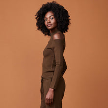 Side view of model wearing the supersoft sweater knit cold shoulder top in moss.