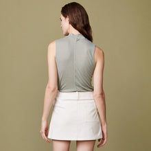 Back view of model wearing the sheer mock neck tank in laurel green.