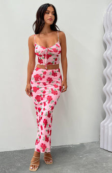 Cropped pink mesh cami with red floral print, cowl neck, spaghetti straps, tie-front, and lettuce hem