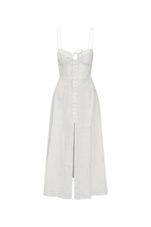 White maxi dress featuring thin spaghetti straps, bustier-inspired cups at the bust with shirring details, a playful keyhole cutout, a center front placket that stops at the hip above a center front slit.