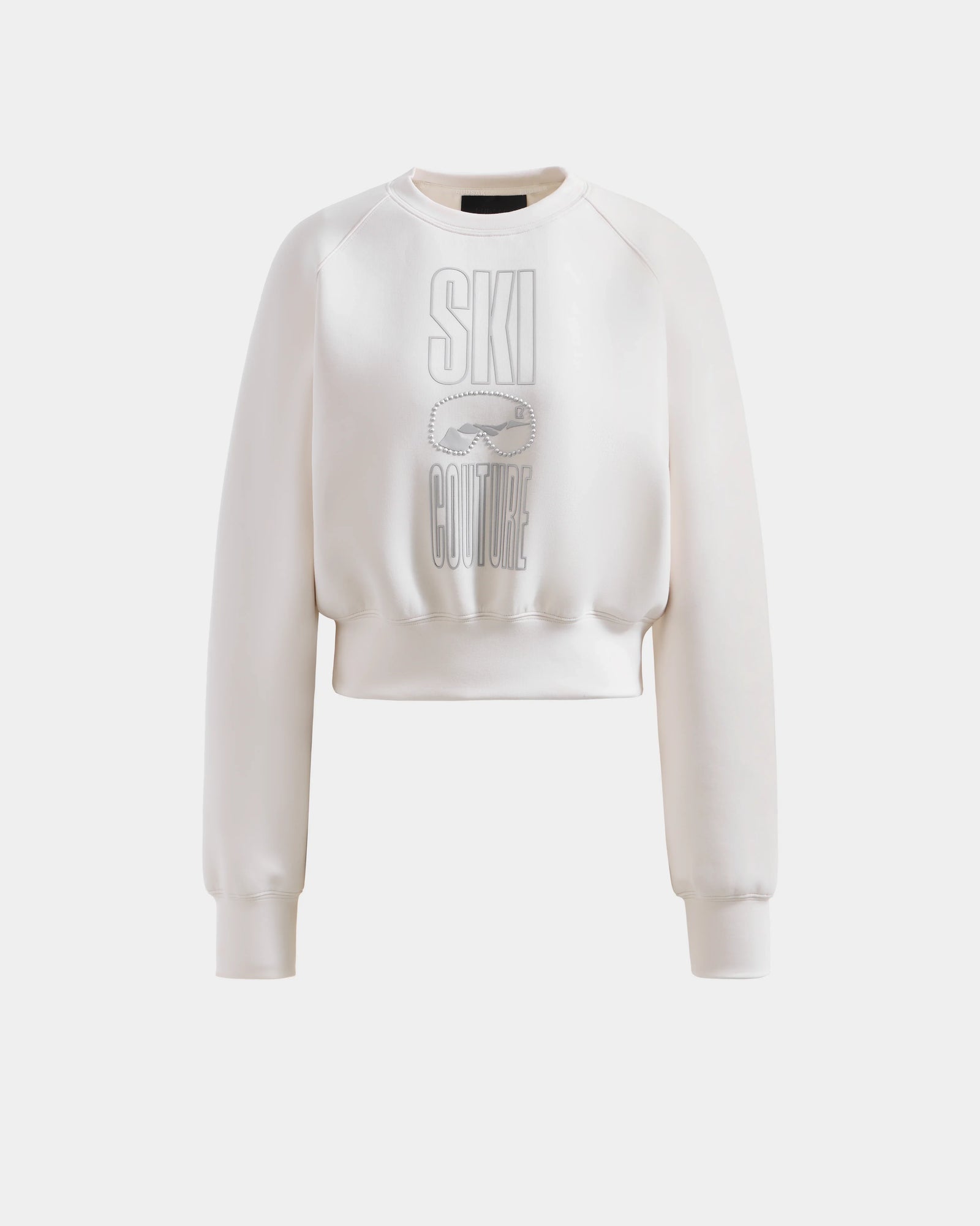 Add a ski-chic touch to your winter look with the Rudsak LIDDIE - L525505 Vanilla sweatshirt, a white cropped crewneck featuring long sleeves and "SKI COUTURE" with a ski goggles graphic on the front.