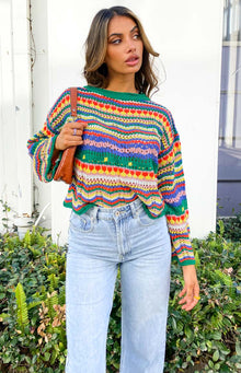 Multi-colour striped crochet knit sweater with green ribbed crew neck, long sleeves, and wavy hem