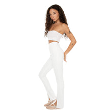 Side profile of model in Kylu Pants in white, showing slim fit and split hem detail. **white