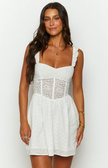 Front view of a white mini dress with a sweetheart neckline, ruffled straps, and a lace corset-style bodice