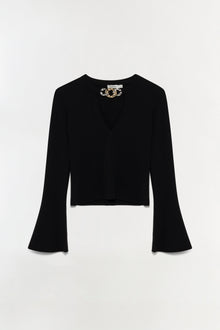 Black wool top with V-neckline, flared long sleeves, and gold chain detail at neckline.