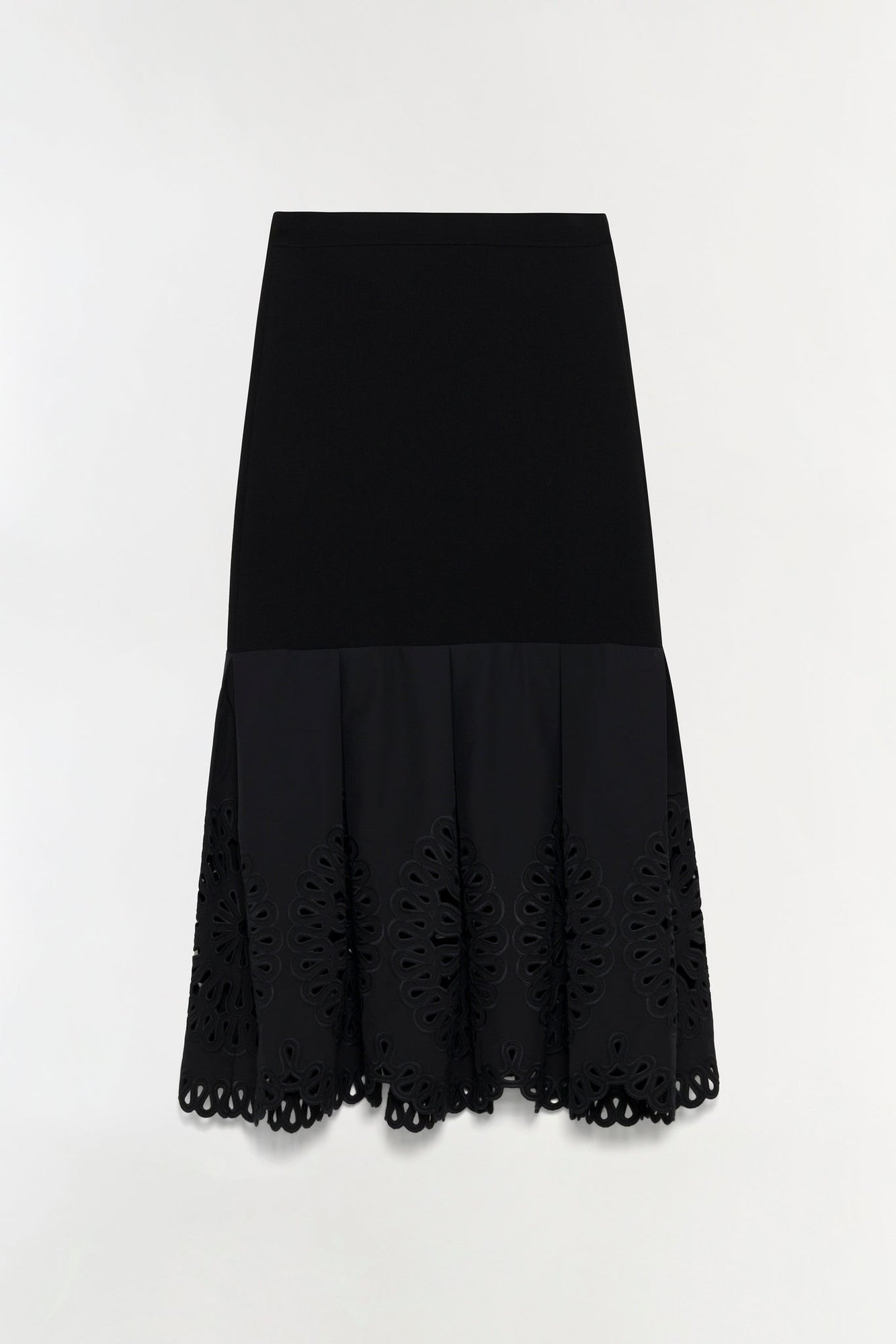 Black knit midi skirt with embroidered cutout detailing along the hem and pleated lower section.